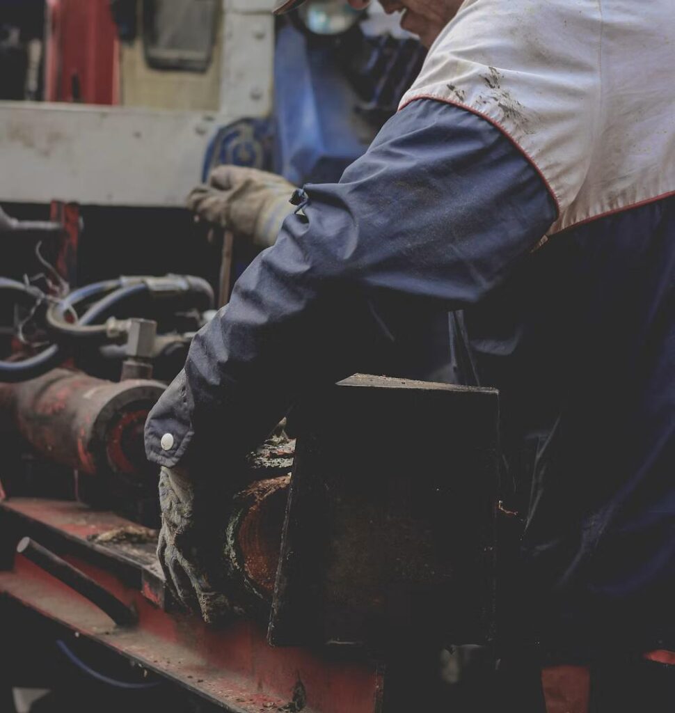 Professional technician carefully working on machinery